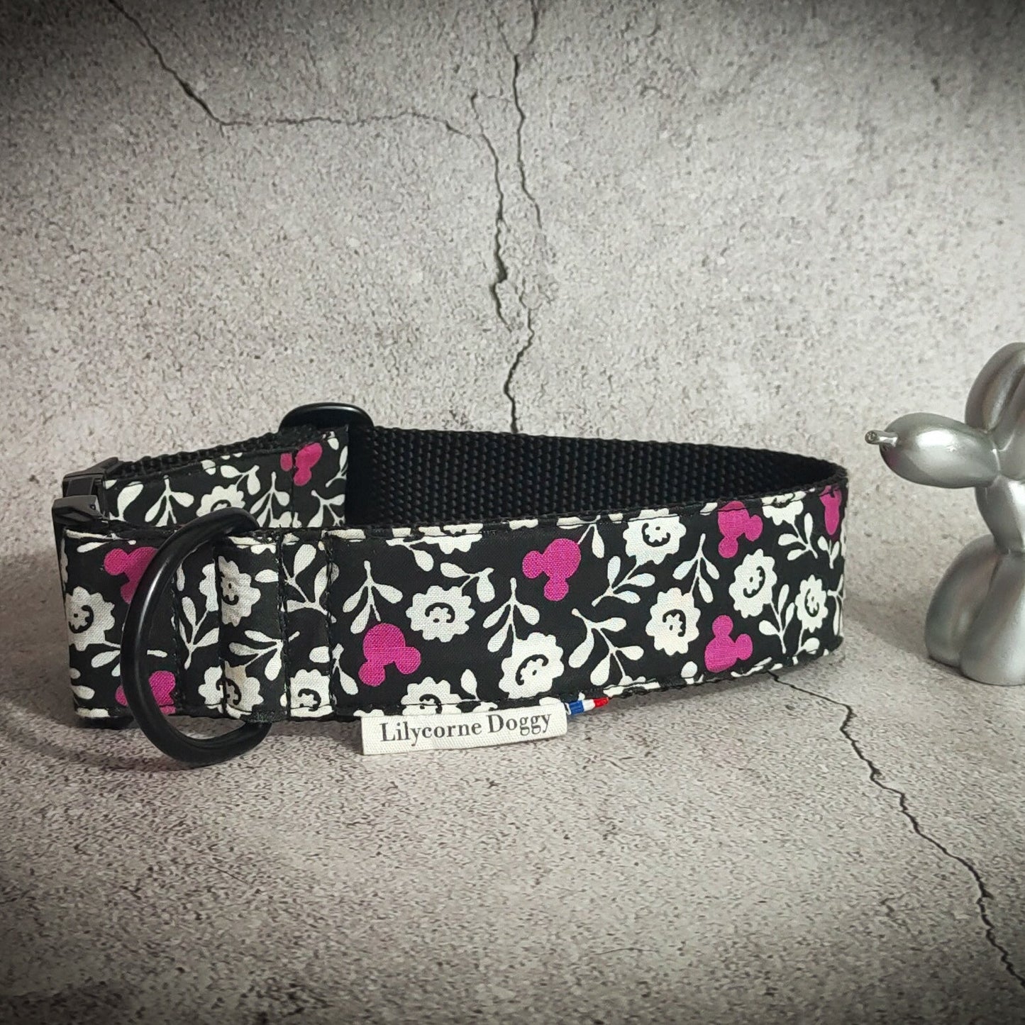 collier pour chien noir avec des fleurs blanche et des têtes de mickey rose. Ce collier pour chien est original, unique et solide. Il est idéal pour les fan de gothique